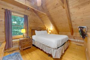 a bedroom with a bed in a log cabin at Whispers of the Smokies Hot Tub Pool Table Grill in Glade +58 photos