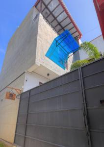 a blue chair sits on top of a fence at Wind Villa Weligama Bay - Vacation House in Weligama +17 photos