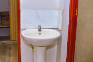 a bathroom with a white sink in a room at Haven Homes in Nakuru