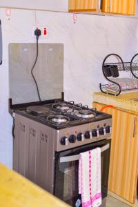 a stove top oven sitting in a kitchen at Haven Homes in Nakuru