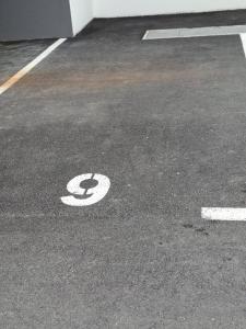 a parking lot with a handicapped sign on the ground at Apartman PEPI LUXURY in Novi Zagreb