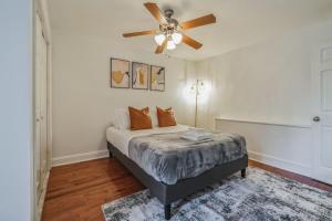 a bedroom with a bed with a ceiling fan at Huge and Sunny 1BR in Center City in Philadelphia
