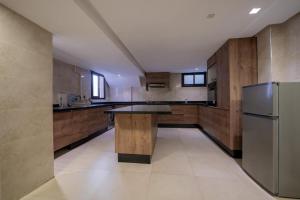 a large kitchen with a table and a refrigerator at Jack Beach Bay in Tamaris
