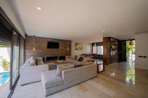 a living room with two couches and a tv at Jack Beach Bay in Tamaris