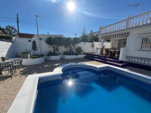 a swimming pool in front of a house at Villa Morar in Benalmádena