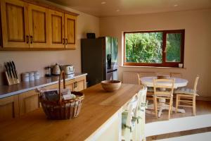 a kitchen with a table and a dining room at A Peaceful Cotswolds Retreat in Bourton on the Water