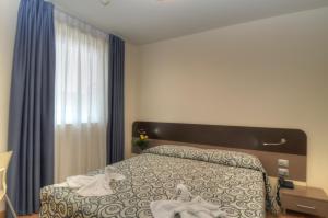 Postel nebo postele na pokoji v ubytování Hotel Pasha