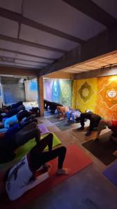 a group of people doing yoga in a room at Ayur nidhi Eco Hostel in Petrópolis