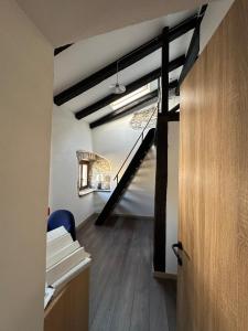 a room with a staircase in the middle of a building at Sailor Nest - Casetta carsica Aurisina in Aurisina +15 photos