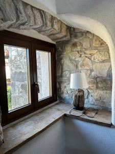 a lamp sitting on a ledge next to a window at Sailor Nest - Casetta carsica Aurisina in Aurisina