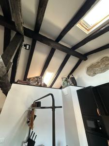 a kitchen with wooden ceilings and a sink in a room at Sailor Nest - Casetta carsica Aurisina in Aurisina