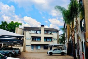 a white truck parked in front of a building at Closer to CBD by UrbanCove in Nelspruit