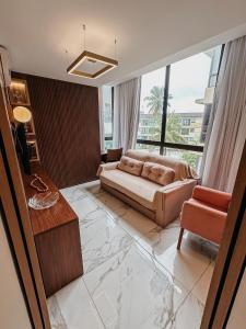 a living room with a bed and a large window at Porto Atlantis by You In | 80m from Porto de Galinhas Beach in Porto De Galinhas +173 photos