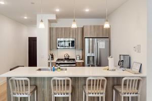 a kitchen with a large island with bar chairs at Blue River Dream in Silverthorne