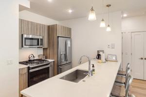 a kitchen with a sink and a stove top oven at Blue River Dream in Silverthorne +4 photos