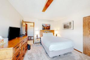 a bedroom with a bed and a flat screen tv at Cozy Corner in Winter Park