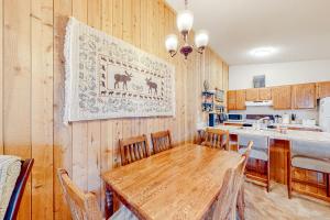 a dining room with a table and a kitchen at Cozy Corner in Winter Park