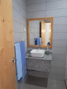 a bathroom with a sink and a mirror at Sinagoga Guesthouse in Ribeira Grande +70 photos
