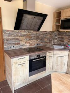 a kitchen with a stove and a sink at Fewo Goldstück in Willingen +12 photos