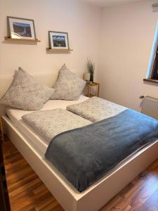 a bed with two pillows on it in a room at Fewo Goldstück in Willingen