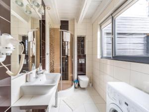 a white bathroom with a sink and a toilet at Comfortable holiday homes close to the beach in Grzybowo +41 photos