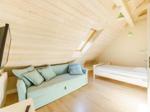 a living room with a couch and a bed at House in Grzybowo near the beach, private sauna in Grzybowo