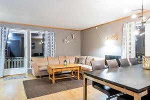 a living room with a couch and a table at Arctic Serenity in Tromsø