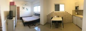 a small room with a staircase and a small table at Cozy apartment near the beach in Haifa
