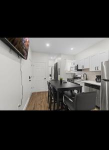 a kitchen with a table and chairs in a room at Modern 2 bedroom 1 bath unit 2 Near Airport, Xfinity Arena and Eagles Stadium in Philadelphia +9 photos