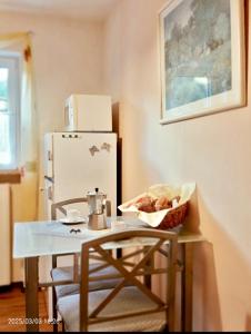 a kitchen with a table and a refrigerator at Ferienwohnungen Ferienhaus Nähe Winterberg Upland in Bromskirchen