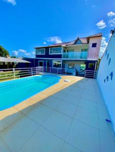a view of a building with a swimming pool at Mar e Sol de Araruama in Araruama