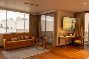 a living room with a couch and a desk at S22 Hotel & Suites in San Luis Potosí