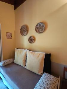 Una habitación con una cama con almohadas y una pared con imágenes de conchas marinas. en Petit Nid Cime Bianche - Appartamento con Vista e Balcone, en Champoluc