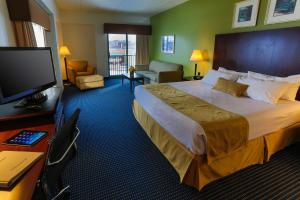 a hotel room with a large bed and a flat screen tv at Grand Harbor Resort and Waterpark in Dubuque