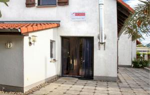 a door to a building with a sign on it at Amazing Home In Rechlin With Wifi in Zielow