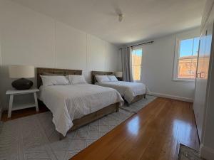 a bedroom with two beds and a window at The Hidden Nook in Armidale