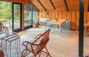 a screened in porch with a table and chairs at 2 Bedroom Gorgeous Home In Græsted in Græsted