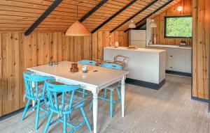 a kitchen and dining room with a table and chairs at 2 Bedroom Gorgeous Home In Græsted in Græsted