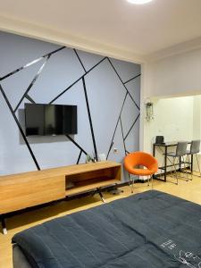 a bedroom with a flat screen tv on a wall at Bat Galim BEACH- Mirror apartment in Haifa