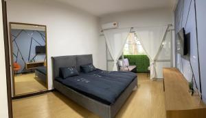 a bedroom with a large bed and a mirror at Bat Galim BEACH- Mirror apartment in Haifa