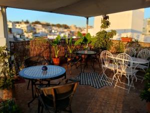 a group of tables and chairs on a patio at Dar Rif Kebdani in Tangier