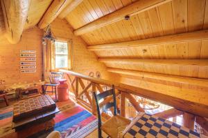 an attic room with a staircase in a log cabin at Andover Cabin Retreat with Hot Tub and Fireplace! in Andover