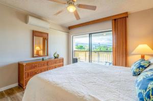 a bedroom with a bed and a large window at Kona Plaza#409 in Kailua-Kona