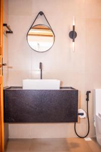 a bathroom with a sink and a mirror at Pousada Chalés 4 Estações in Caparaó Velho +23 photos