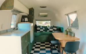 a kitchen and dining area of a tiny house at Airstream Caravan at Matakana Retreat in Matakana
