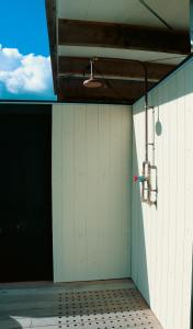 an empty room with a white wall and a ceiling at Airstream Caravan at Matakana Retreat in Matakana