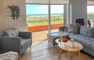 a living room with two couches and a table at 3 Bedroom Amazing Home In Sjølund in Binderup Strand