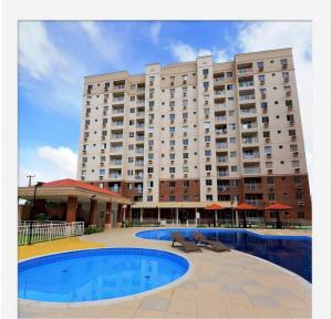 a large building with a swimming pool in front of it at Apartment in Ananindeua in Ananindeua