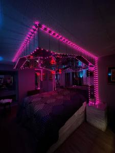 a room with a bed with pink lights on it at Executive Inn Coopersburg in Coopersburg +20 photos