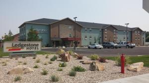a sign for a hotel in front of a building at Ledgestone Suites Hotel Vernal in Vernal